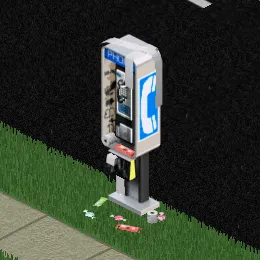 A pay phone with some candy littered around it